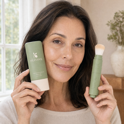 Woman holding Color Correcting Serum in Medium and the powder brush
