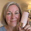 Delphine A, verified buyer, holding the Tone Adapting CC Serum